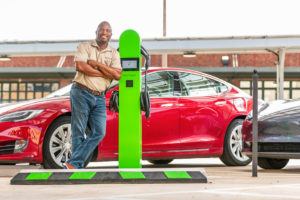 Edward Morgan stands in front of his Revitalize Charging Solutions vehicle charger